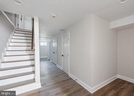 interior space featuring baseboards and wood finished floors