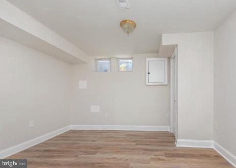 interior space featuring visible vents, baseboards, and wood finished floors