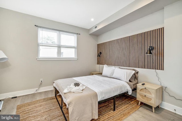 bedroom featuring recessed lighting, wood finished floors, visible vents, and baseboards