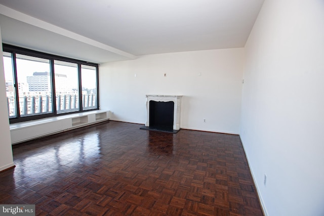 unfurnished room featuring a fireplace and baseboards