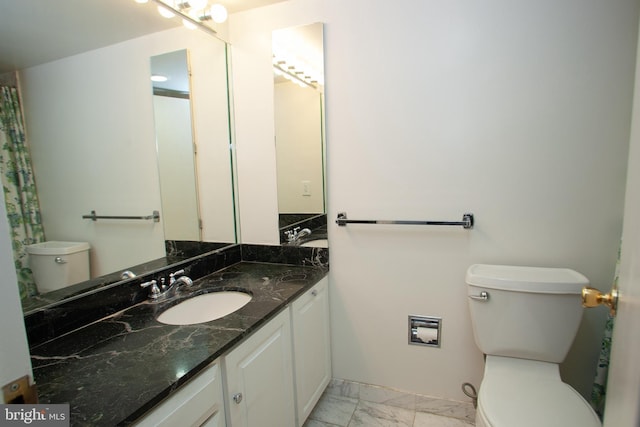 bathroom featuring marble finish floor, toilet, and vanity