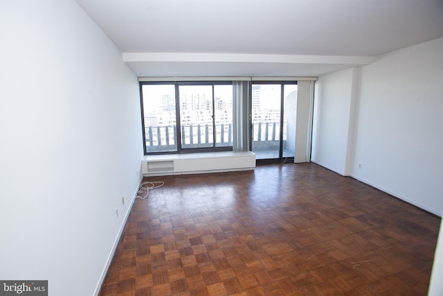 spare room featuring baseboards