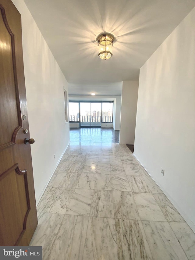 hall featuring marble finish floor