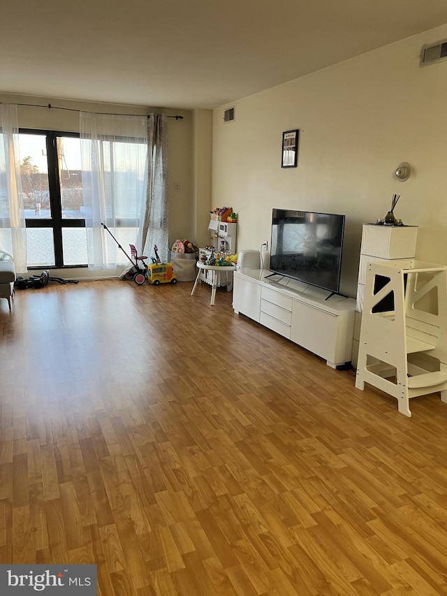 unfurnished living room featuring visible vents and light wood-style flooring