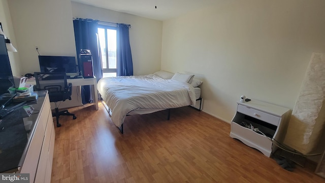 bedroom with wood finished floors