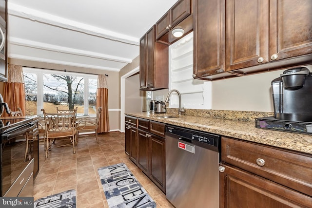 kitchen featuring light tile patterned floors, light stone counters, appliances with stainless steel finishes, and a sink