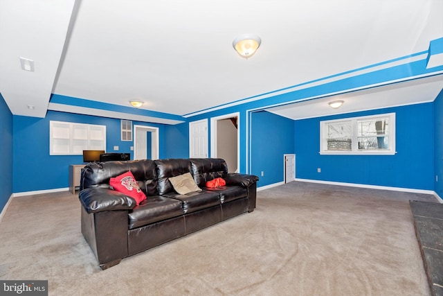 carpeted living room with baseboards