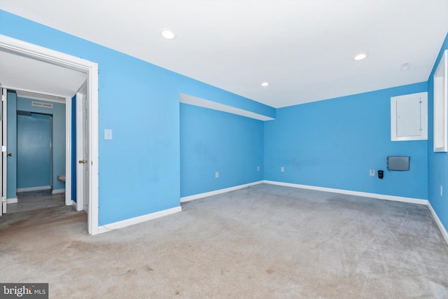 additional living space with carpet flooring, electric panel, recessed lighting, and baseboards