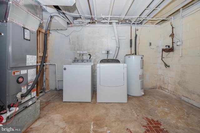 washroom with water heater, laundry area, washing machine and dryer, and heating unit