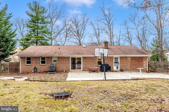 back of house with brick siding, a patio area, and fence