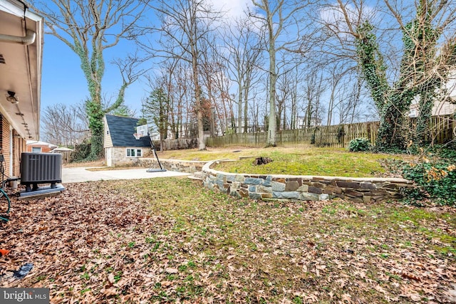 view of yard featuring a patio area, central AC unit, and a fenced backyard