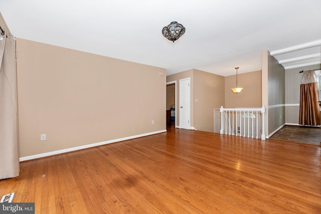 interior space with baseboards and wood finished floors