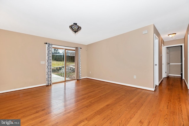 empty room featuring light wood-style floors and baseboards