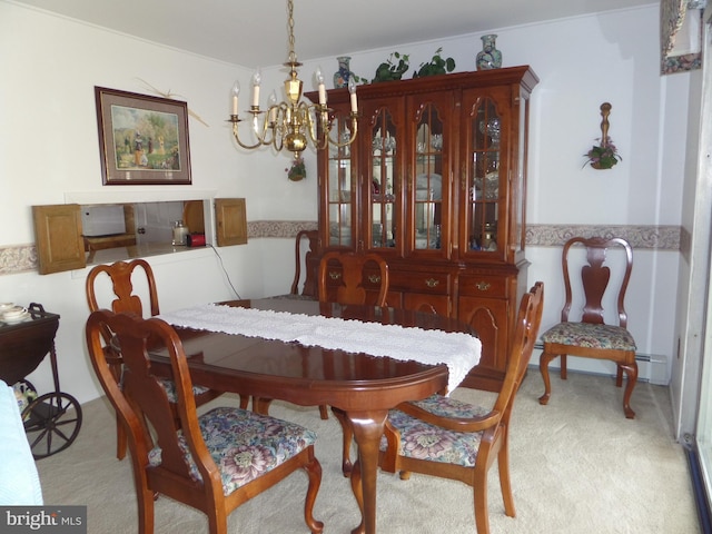 dining room featuring a baseboard heating unit, an inviting chandelier, and light colored carpet