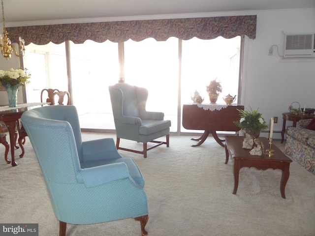 carpeted living area featuring a baseboard heating unit, a wall unit AC, a notable chandelier, and ornamental molding