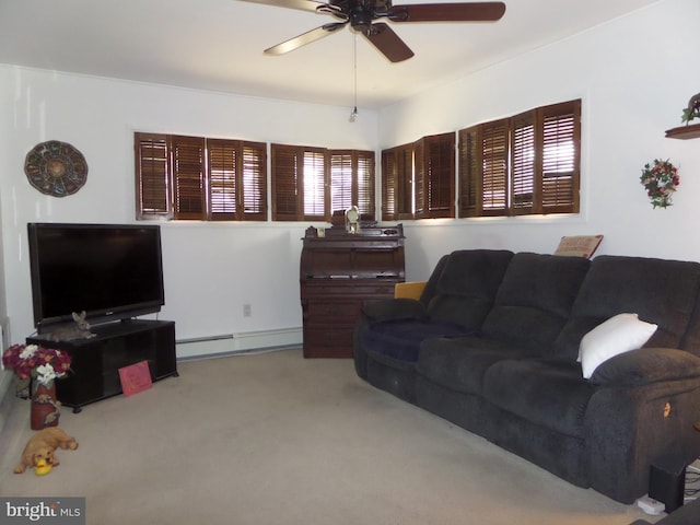 living area featuring a ceiling fan, baseboard heating, and carpet floors