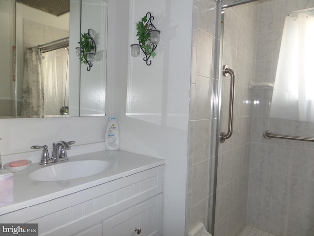 full bathroom featuring a stall shower and vanity