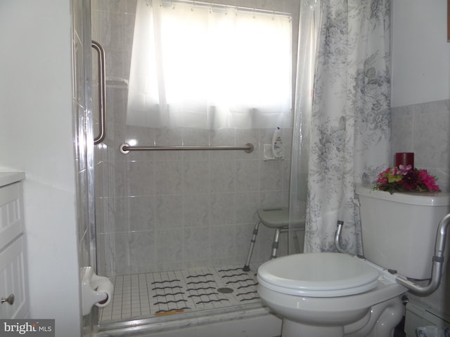 full bathroom with a shower stall and toilet