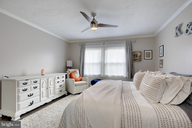 bedroom featuring ornamental molding, ceiling fan, a textured ceiling, and wood finished floors