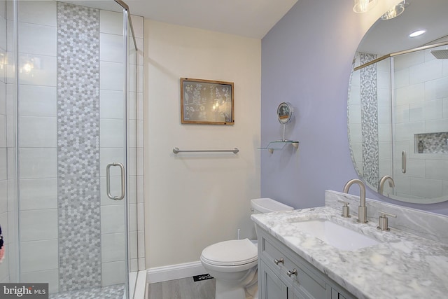 full bath with a stall shower, baseboards, and toilet