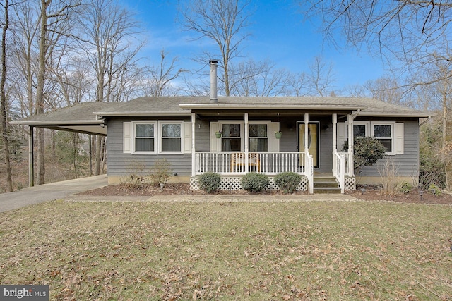 bungalow featuring covered porch, a carport, a front lawn, and concrete driveway