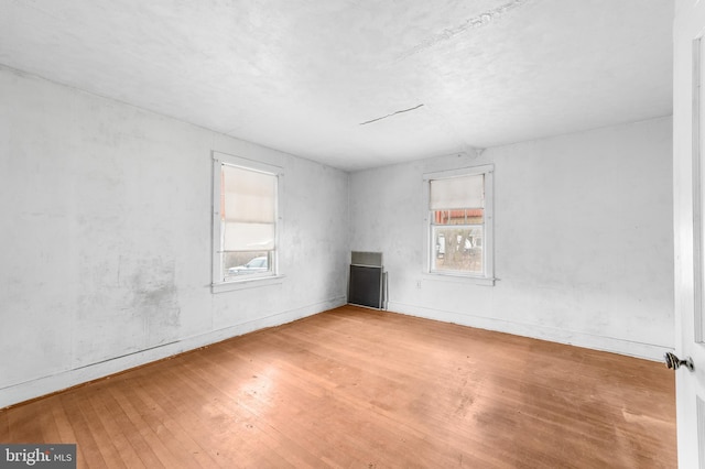 spare room with hardwood / wood-style flooring