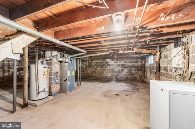 unfinished basement featuring washer / dryer, heating unit, and water heater