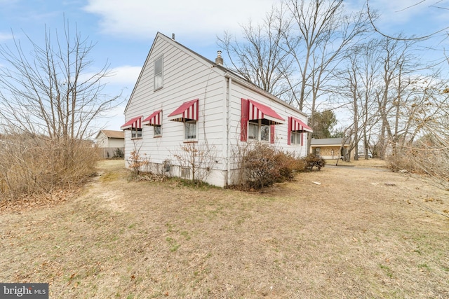 view of side of property featuring a chimney