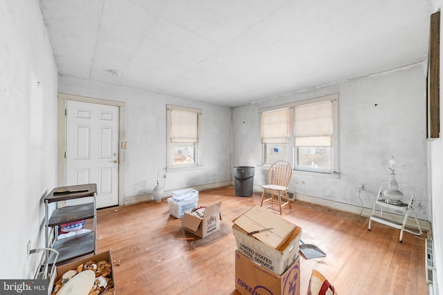 living area with plenty of natural light and hardwood / wood-style floors