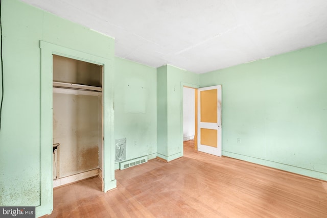 unfurnished bedroom with visible vents and a closet