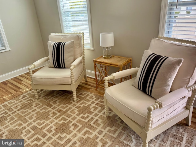 sitting room with light wood-style flooring and baseboards