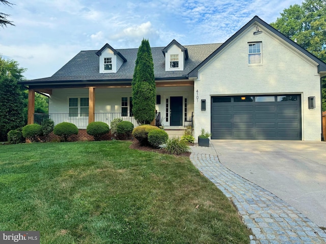 view of front of home featuring brick siding, a porch, concrete driveway, and a front yard