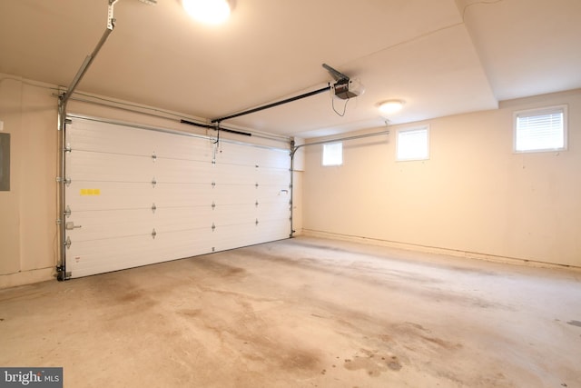 garage with a garage door opener and electric panel