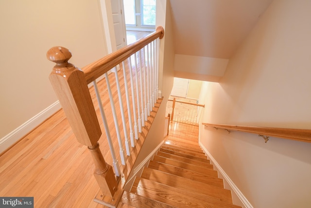 stairs with baseboards and wood finished floors