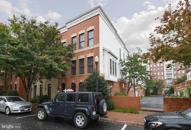 view of building exterior with uncovered parking