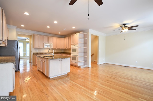 kitchen with crown molding, open shelves, a sink, light wood-type flooring, and white appliances