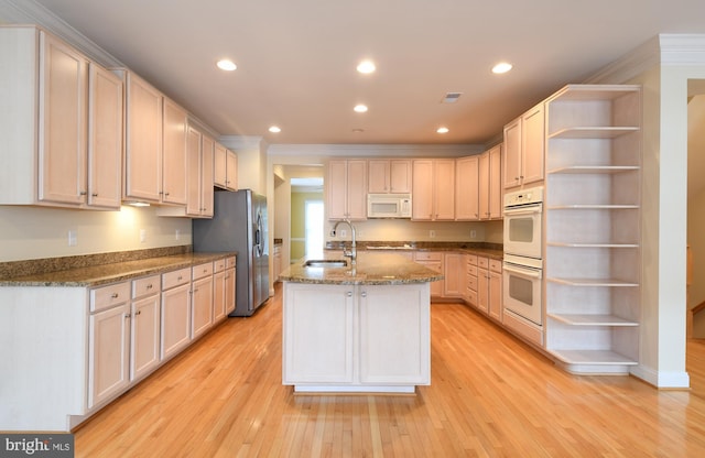 kitchen with white appliances, a sink, light wood-style floors, open shelves, and crown molding