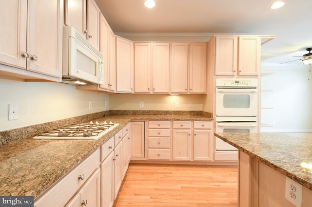 kitchen featuring white appliances, light wood finished floors, ceiling fan, light stone counters, and recessed lighting