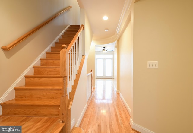 staircase featuring ceiling fan, baseboards, wood finished floors, and recessed lighting