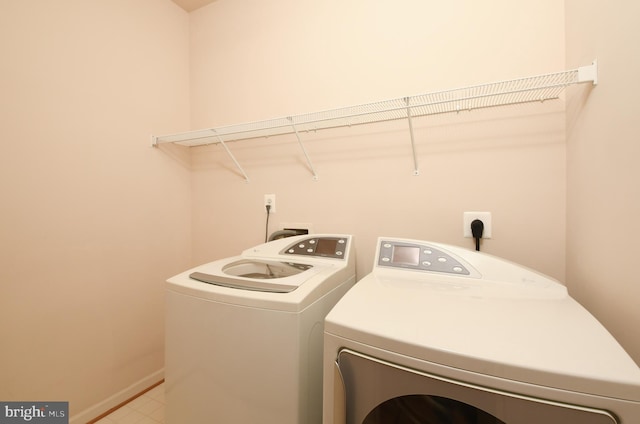 laundry area with washing machine and dryer, laundry area, and baseboards