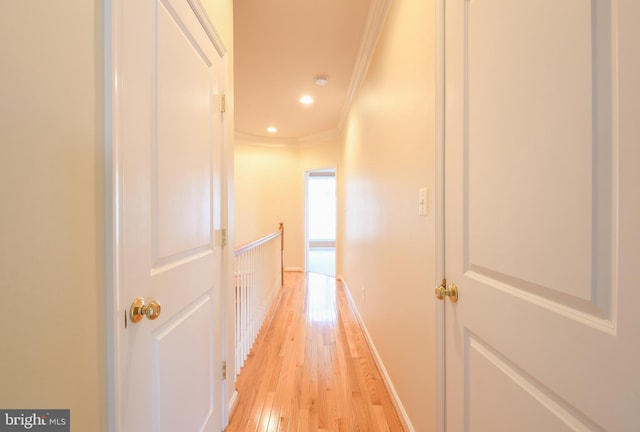 corridor featuring baseboards, ornamental molding, an upstairs landing, light wood-type flooring, and recessed lighting