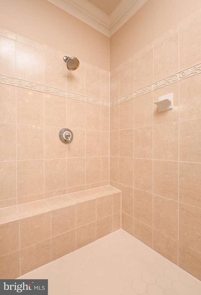 bathroom featuring tiled shower and crown molding