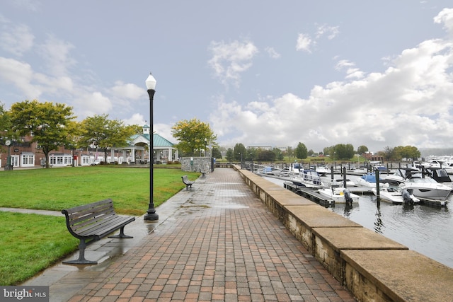 view of dock featuring a water view and a lawn