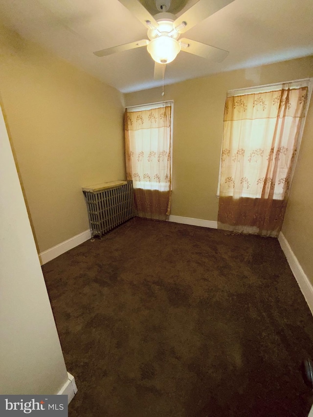 spare room with ceiling fan, baseboards, and carpet flooring