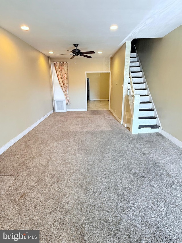 interior space with carpet, visible vents, stairway, and baseboards