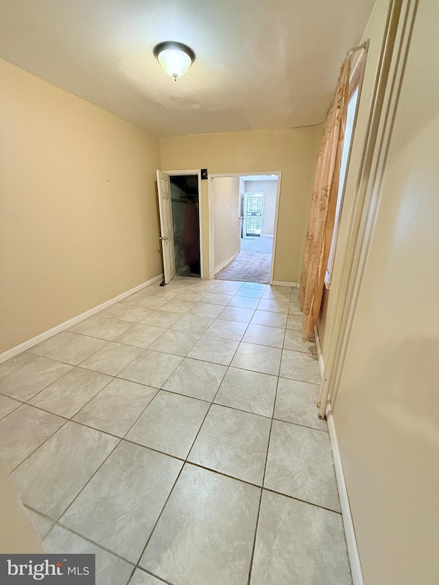 unfurnished bedroom featuring baseboards and light tile patterned floors