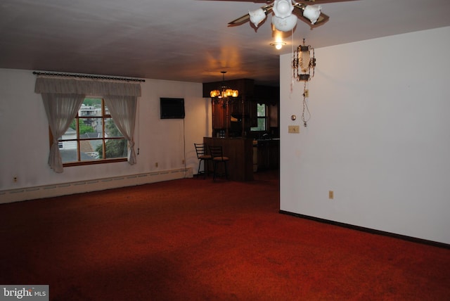 unfurnished living room featuring carpet floors, baseboards, a baseboard heating unit, and ceiling fan with notable chandelier