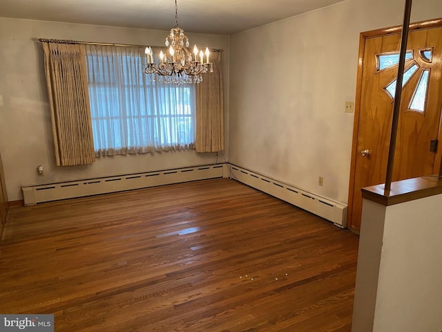 unfurnished dining area featuring baseboard heating, hardwood / wood-style floors, and an inviting chandelier