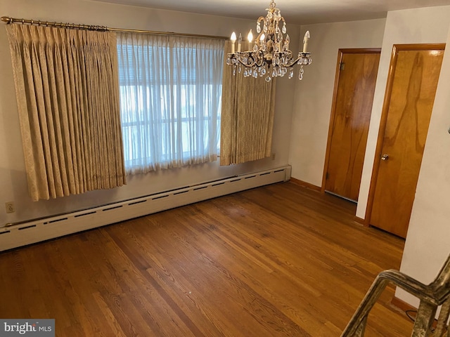 unfurnished dining area with baseboards, a chandelier, baseboard heating, and wood finished floors