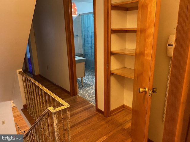 interior space featuring baseboards and wood finished floors